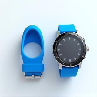 Sport Silicone Band in blue, laid out next to Zenith Smartwatch